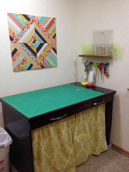 Cutting table with rulers and pin board.