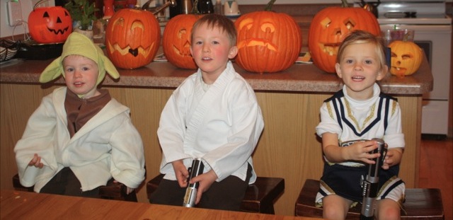 The kiddos in their costumes with the pumpkins.