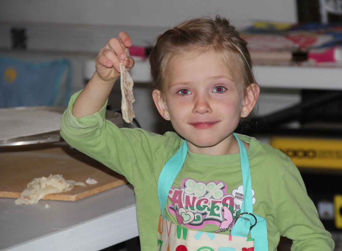 Little fingers are always there to help clean up lefse droppings.